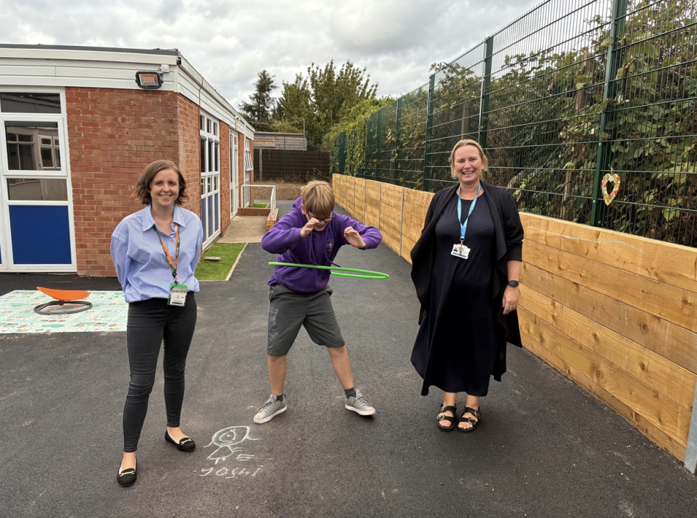 Cllr Kate Tomlinson, Cabinet Member for Children and Education (left) with Gemma Meiklejohn, Headteacher at Crowdys Hill School enjoying Logan’s hula hoop skills