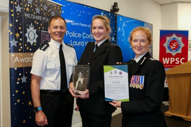 PC Laura Hughes, centre, receives her certificate from Chief Constable Catherine Roper